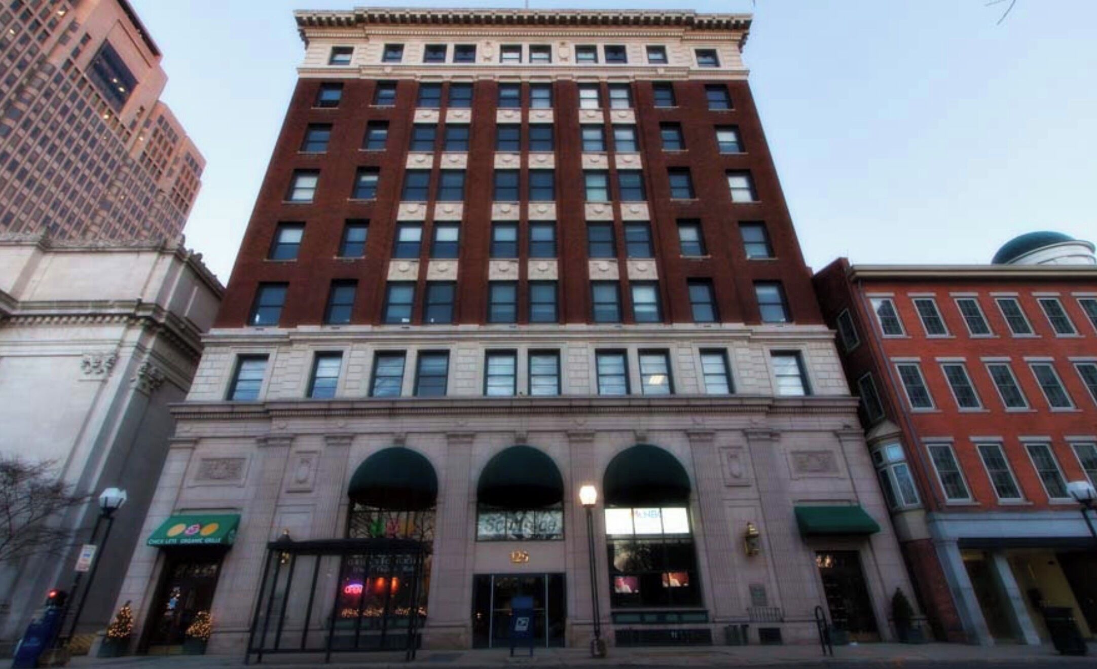 A multi-story building with a central entrance, large windows, and a classic architectural style.