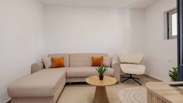 Deluxe Suite, 2 Bedrooms, Garden View, Ground Floor | Living area | 28-inch Smart TV with digital channels