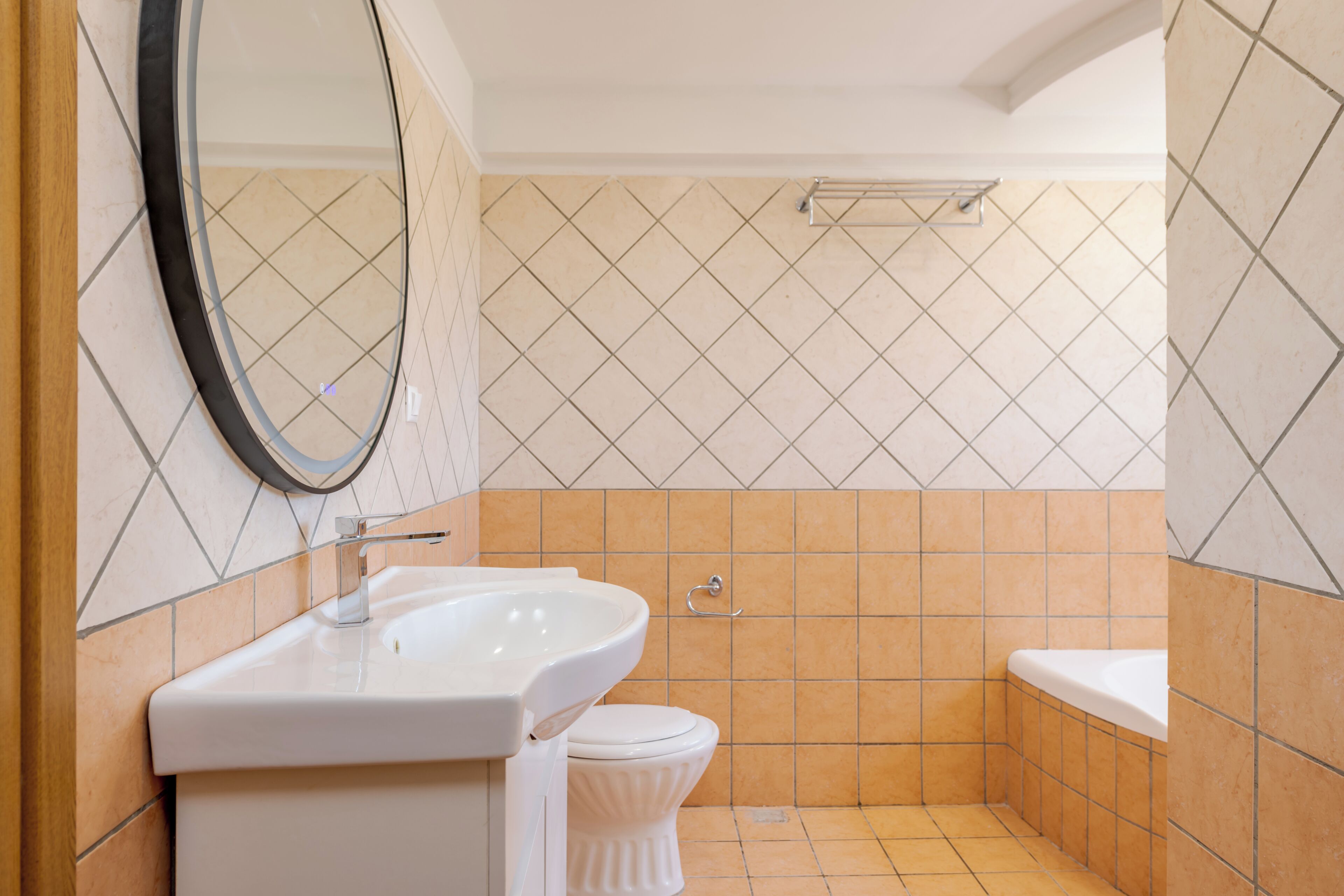 A bathroom with a sink, toilet, and bathtub.