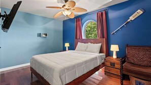 A bedroom with a bed, two bedside tables with lamps, a ceiling fan, a window with curtains, and a wall-mounted shelf. - Riviera Paradise Lake Luxury (Sunrise Beach)
