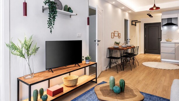 A modern living room with a TV, dining area, and kitchen. - Gorgeous 3 Bedroom Apartment At Monnas Suite (Istanbul)