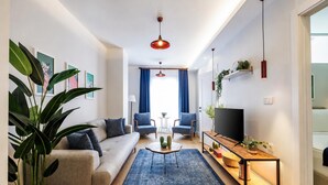 A modern living room with a sofa, coffee table, and TV stand. - Gorgeous 3 Bedroom Apartment At Monnas Suite (Istanbul)