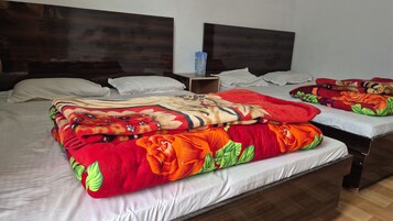 A hotel room with a large bed, two bedside tables, and a headboard.
