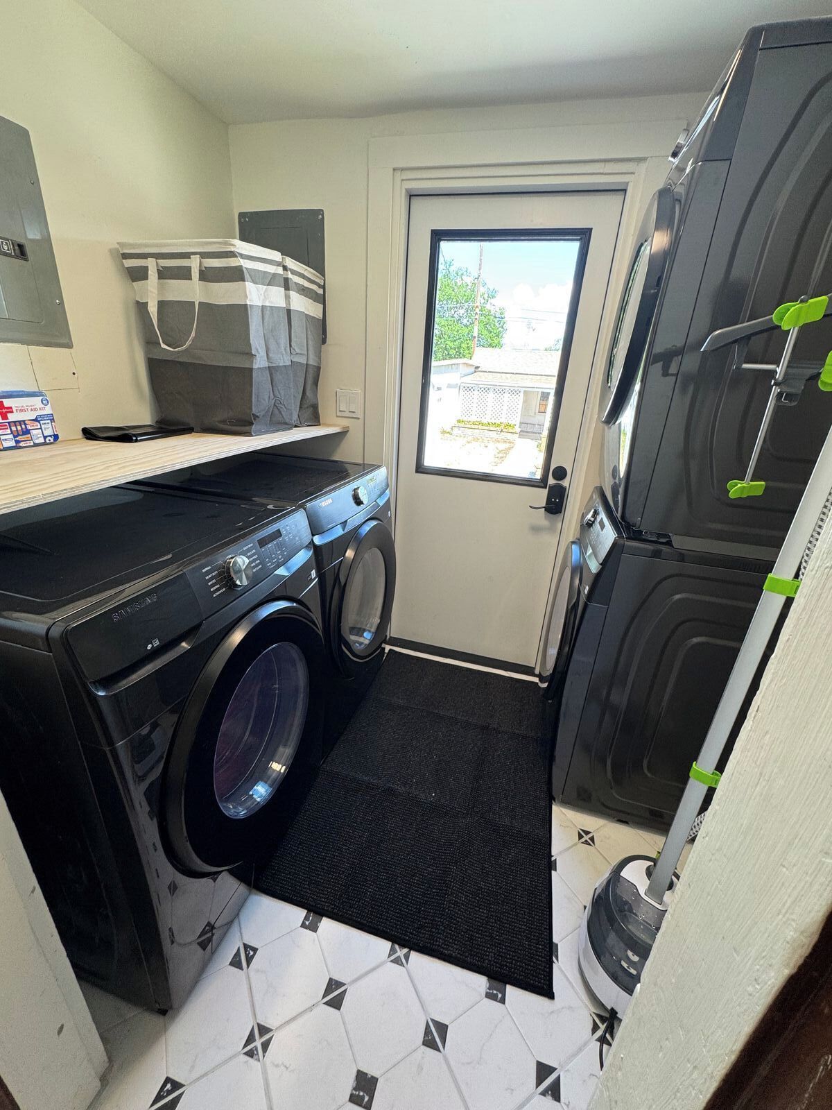 A compact laundry room with a washing machine, dryer, and a small countertop.
