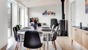 A modern dining area with a round table, chairs, and a cityscape painting on the wall. - "Bilal" - 1.8km from the sea by Interhome (Rømø)