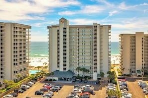 A multi-story hotel with a pool and beach view, parking lot, and multiple balconies. - 2nd Floor Corner Unit Condo with 3BR, 2BA in beautiful Orange Beach! (Orange Beach)