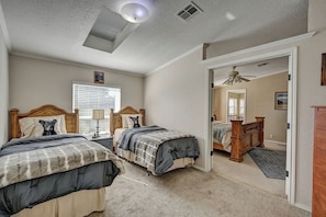 A bedroom with two beds, a ceiling fan, and a window with blinds. - Bear's Den | Secluded, Pet-Friendly Getaway (Buena Vista)