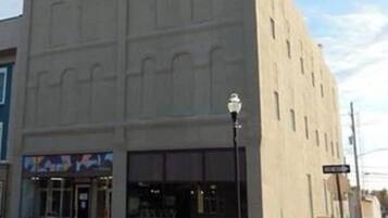 A building with a flat facade, large windows, and a street lamp.