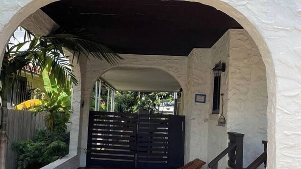 An arched entrance with the number 2267, a covered seating area, and a gated pathway. - 2 Bedroom House in the Heart of Miami + Parking (Miami)