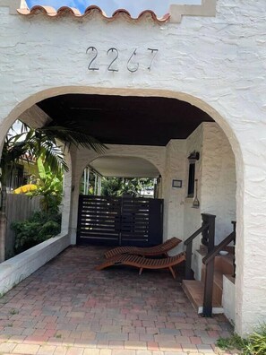 An arched entrance with the number 2267, a covered seating area, and a gated pathway. - 2 Bedroom House in the Heart of Miami + Parking (Miami)