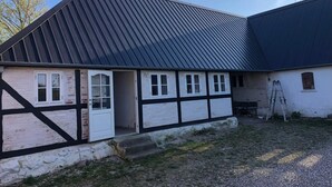 A building with a sloped roof, a door, and windows. - 4 Star Holiday Home in Rudkobing (Rudkobing)