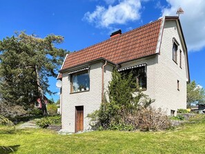 A single-story house with a red-tiled roof, a brick exterior, and a small front porch. - 5 Person Holiday Home in Gunnebo (Gunnebo)