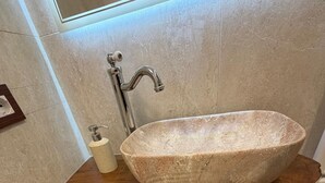 A bathroom with a stone sink, a soap dispenser, and a towel rack. - Terme house (Bagni San Filippo)