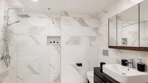 A modern bathroom with a shower, toilet, and vanity. - Glamorous Cihangir 3 Bedrooms Apt At Monnas Suite (Istanbul)