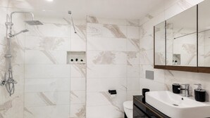 A modern bathroom with a shower, toilet, and vanity. - Fantastic Cihangir 3 Bedroom Apt At Monnas Suite (Istanbul)