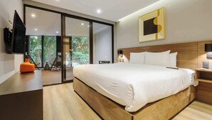 A modern bedroom with a large bed, a TV, a wooden headboard, and a sliding glass door leading to a balcony. - w* | Stylish 2BR w/ AC in the Heart of Roma Sur (Ciudad de México)