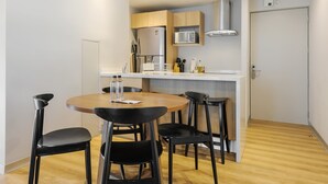 A compact kitchen with a microwave, refrigerator, and modern cabinetry. - w* | Stunning 1BR w/ AC in the Heart of Roma Sur (Ciudad de México)