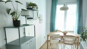 A modern kitchen with a dining area, wooden flooring, and a window with curtains. - Peaceful 1-bedroom apartment with AC in wonderful Beograd (Beograd)