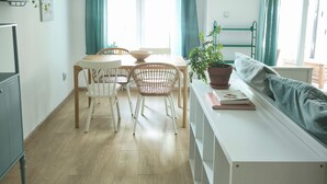A modern kitchen with a dining area, wooden flooring, and a view of the outdoors. - Peaceful 1-bedroom apartment with AC in wonderful Beograd (Beograd)