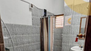 A bathroom with a shower, toilet, and sink. - Umay Lodge: A House in the Mountains (Urubamba)