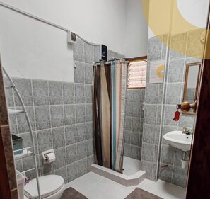 A bathroom with a shower, toilet, and sink. - Umay Lodge: A House in the Mountains (Urubamba)
