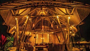 A circular wooden structure with a central seating area and a staircase leading to the roof. - Cacao House Eco-luxe Family Home Near Green School (Abiansemal)
