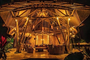 A circular wooden structure with a central seating area and a staircase leading to the roof. - Cacao House Eco-luxe Family Home Near Green School (Abiansemal)