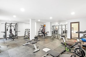 A gym with various exercise equipment, including weight machines, benches, and cardio machines. - Cerro Colorado Studio Condo in Cabo San Lucas (Cabo San Lucas)