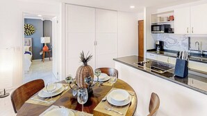 A modern kitchen with white cabinets, a microwave, and a coffee machine. - Cerro Colorado Condo Condo in Cabo San Lucas (Cabo San Lucas)