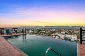 A rooftop pool with a view of a cityscape and mountains in the distance. - Cerro Colorado Condo Condo in Cabo San Lucas (Cabo San Lucas)