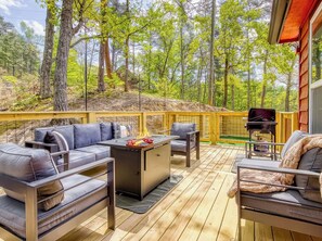 An outdoor deck with a sofa set, a grill, and a dining table. - Hot Tub-Cozy-MountainViews-10min to Pigeon Forge (Pigeon Forge)