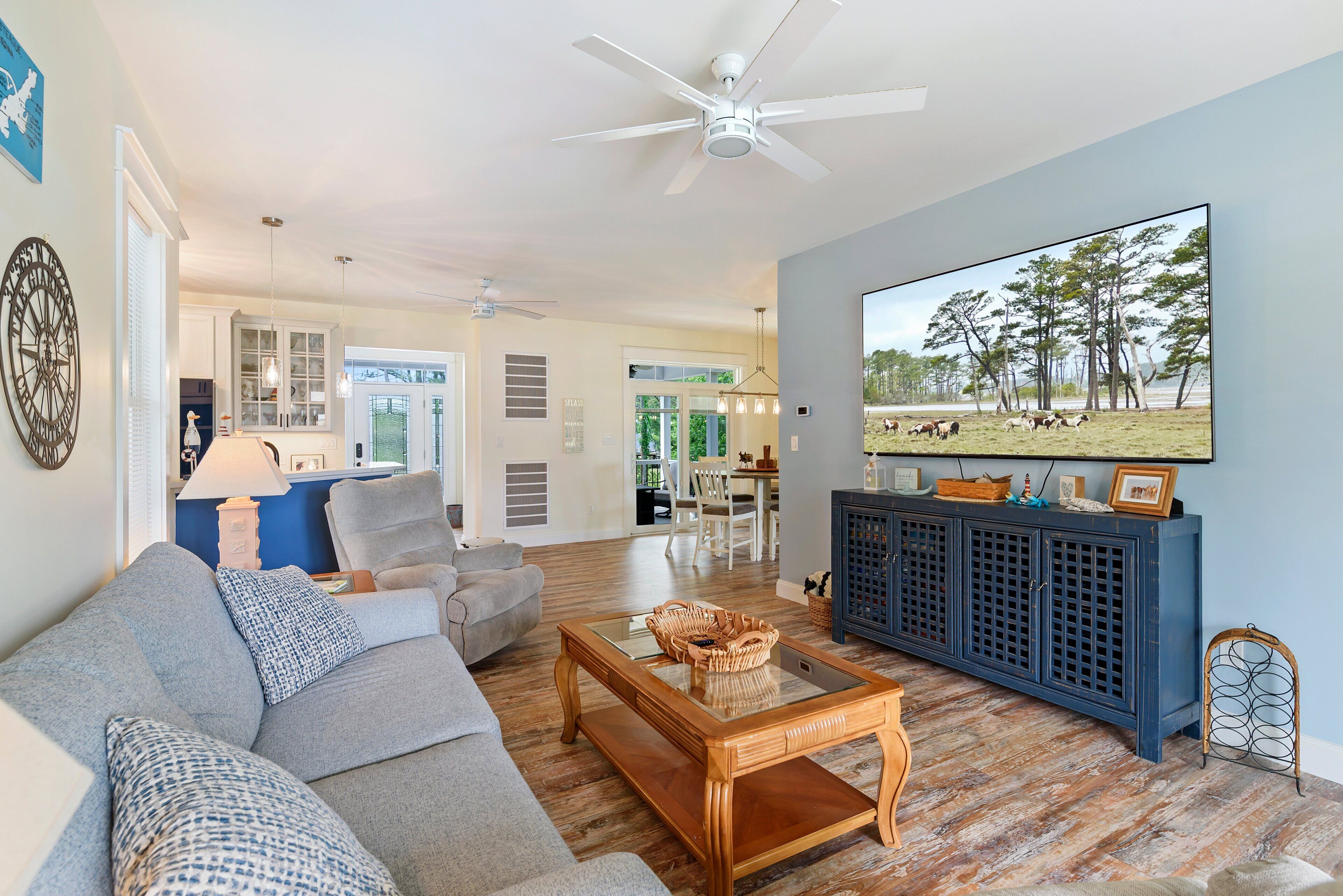 A living room with a sofa, coffee table, TV, and a blue cabinet.