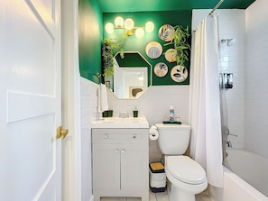 A bathroom with a toilet, sink, and shower. - Chic Boho Paradise: Las Olas (Oakland Park)