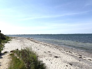 A beach with a sandy shore, clear water, and a distant shoreline. - "Velena" - 150m from the sea by Interhome (Slagelse)