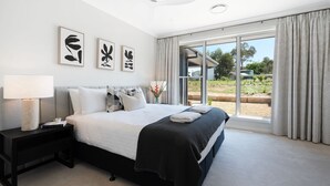 A modern bedroom with a bed, bedside table, and artwork on the wall. - Misty Ponds, Countryside at Berrima (Berrima)