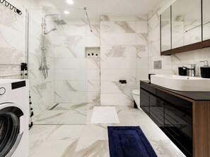 A modern bathroom with a shower, toilet, and sink. - Gorgeous 3 Bedroom Apartment At Monnas Suite (Beyoglu)