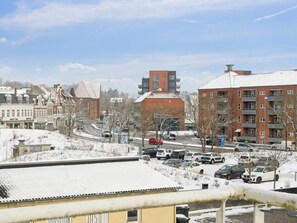 A snowy urban street with buildings, parked cars, and a clear sky. - 4 Star Holiday Home in Aabenraa (Aabenraa)