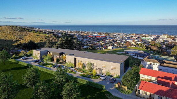 A modern building with a parking lot, surrounded by greenery and residential areas. - Joy 40 Apartments Oamaru (Oamaru)