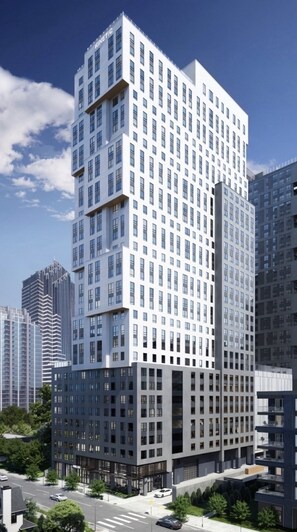 A modern high-rise building with a grid of windows, surrounded by other high-rise buildings. - High-rise comfort in Midtown; Atlanta’s most walkable neighborhood (Atlanta)