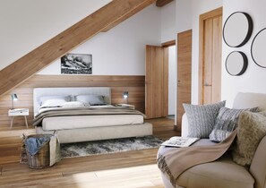 A bedroom with a sloped ceiling, a bed with a headboard, a nightstand, a lamp, a wicker basket, a sofa, and a door. - TSV Les Sources de Canop e 4p8p Duplex (Saint-Gervais-les-Bains)