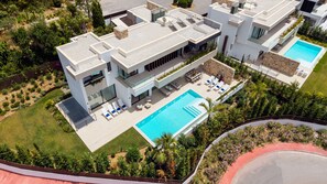 A modern multi-story building with a rooftop pool, outdoor seating, and lush landscaping. - Villa The Address by Vacation Marbella (Marbella)