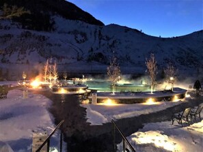 A snow-covered outdoor area with a pool, benches, and trees. - Farmhouse Retreat Near Yellowstone National Park Perfect for Groups (Gardiner)