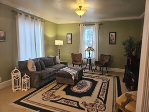 A living room with a sofa, two armchairs, a coffee table, a patterned rug, and a lamp. - Farmhouse Retreat Near Yellowstone National Park Perfect for Groups (Gardiner)