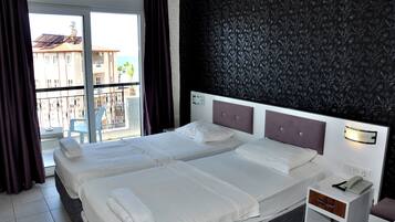 Classic Twin Room, Balcony, Beach View | Desk, laptop workspace, blackout curtains, soundproofing