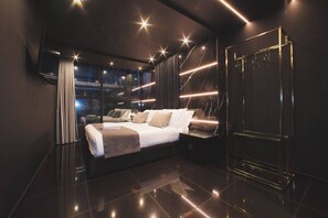 A modern bedroom with a bed, bedside tables, a wardrobe, and a large window. - Aman Luxury 23 Bedroom 3 Pool (Medellín)