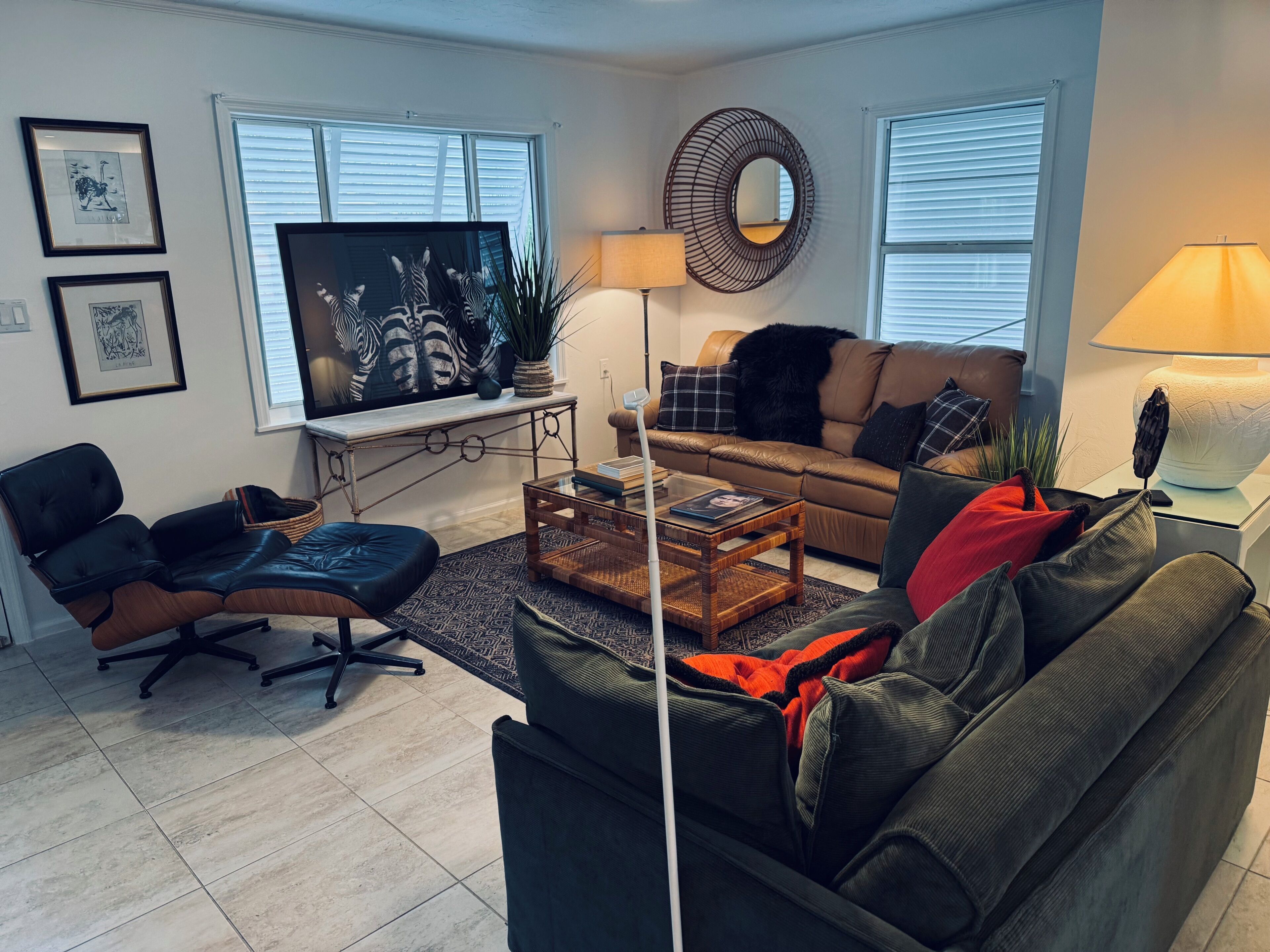 A living room with a sofa, a coffee table, a TV, and a lamp.