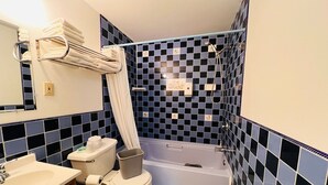 Ein Badezimmer mit Badewanne, Toilette, Waschbecken und Handtuchhalter.
