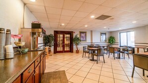 A hotel lobby with a reception desk, seating area, and a large window. - Suite - King Bed Accessible Non Smoking (Jonesboro, AR)