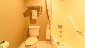 A bathroom with a toilet, a shower, and a towel rack. - 2 Queen Beds Suite Non-Smoking (Jonesboro, AR)
