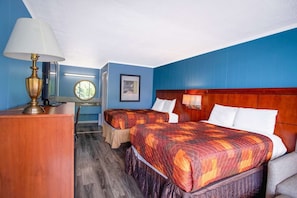 A hotel room with two beds, a desk, a lamp, and a view of the outdoors. - 2 Full Bed|Smk|Kernersville NC (Kernersville NC)